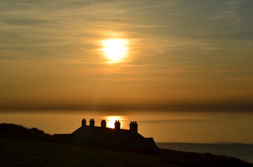 Obraz premium Sunset Over Coastguard Cottages On Tennyson Down, Isle of Wight
