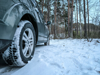 Car tires in the snow close-up. Winter tires as the basis of travel safety in the winter season