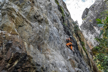 climber with sports pants demonstrating confidence and purpose in her goals to achieve an objective risking everything but at the same time safely
