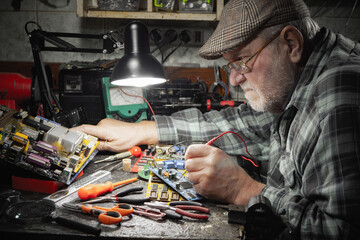 Technician repairing a computer in a workshop. Selective focus.