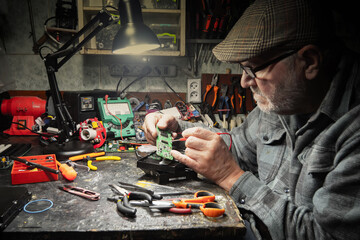 Technician repairing a computer in a workshop. Selective focus.