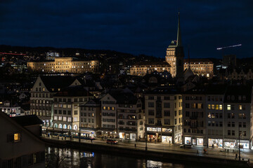 Nighttime View of Historic City Center with Illuminated Cathedral and Buildings in Zurich