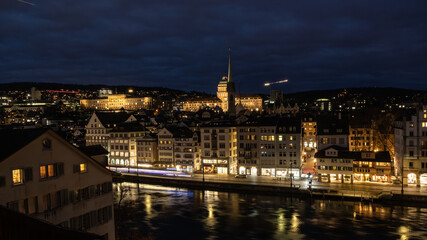 Nighttime View of Historic City Center with Illuminated Cathedral and Buildings in Zurich
