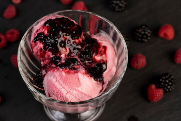 raspberry cream ice cream with ripe raspberries and blackberries