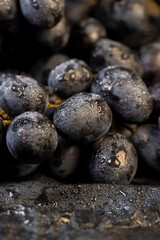 fresh grapes are lying on black paper