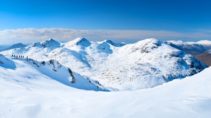 Panoramic View of Snowy Mountains Under Clear Blue Sky in Winter Wonderland Setting