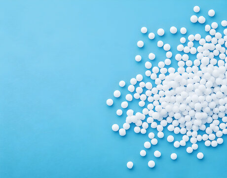 A Pile of White Homeopathic Pellets on a Blue Background