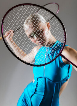 athletic girl holds rackets for bambinton