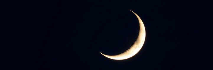 Crescent Moon Glowing Mysteriously Against Dark Night Sky with Copy Space