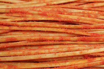 Top view of the texture of Indonesian traditional food stick noodles, Street food. sprinkled with balado chili powder (Mie Lidi).