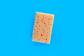 Cleaning kitchen dishwashing sponge on blue background
