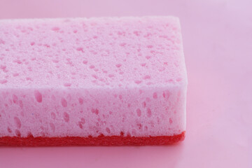 Cleaning kitchen dishwashing sponge on pink background