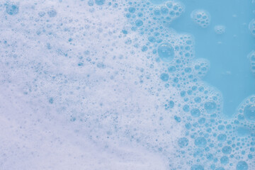 Detergent foam bubble on water. Blue background, Soap sud