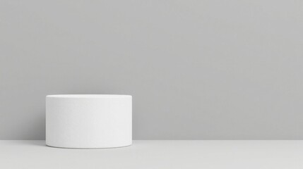 Minimalist white cylindrical pedestal against a neutral backdrop, perfect for showcasing products or designs with a clean and modern aesthetic