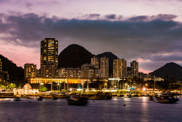 Naklejka premium Modern Buildings Skyline With Mountains Silhouette After Sunset in Rio de Janeiro, Brazil