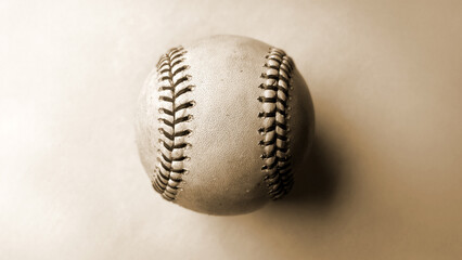 an antique vintage baseball, weathered with age, displays intricate stitching and a timeless charm, evoking memories of past games and sporting history