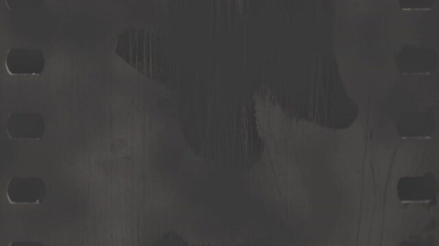 Scratched black and white film strip adds vintage charm to any design. A perfect texture or background choice for a touch of nostalgia