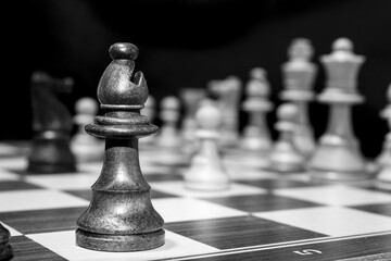 Chessmen photographed on a chessboard with a dark background
