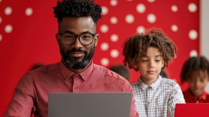 Diverse group of children engaged with male teacher using laptop for interactive education in classroom environment