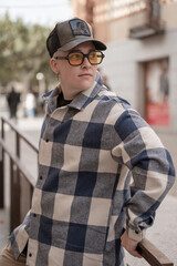 Street Style: Casual Urban Outfit with Checkered Shirt and Black Cap