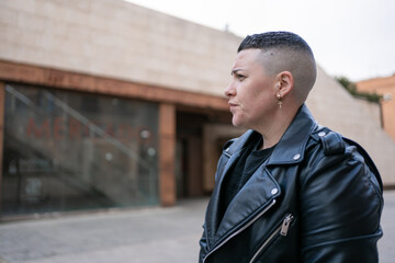 Lesbian woman wearing black leather jacket showing masculinity and pride