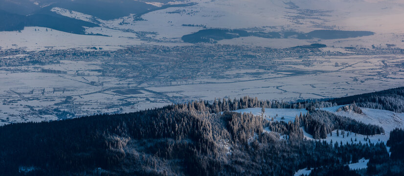View of the city of Miercurea Ciuc in winter, in front with the forest and the Kossuth rock. Romania, Harghita country. 
