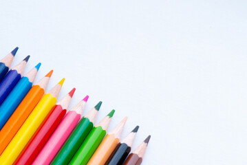 A vibrant arrangement of colored pencils positioned neatly on a light background, perfect for drawing and crafting.