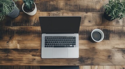 A top view of a modern workplace interior showcases a wooden desk with a laptop featuring a mockup screen.