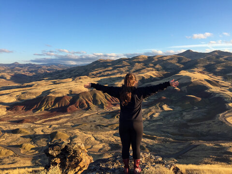 Person Enjoying Panoramic View of Painted Hills at Sunset