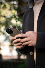 Close up of a businessman looking at his cell phone
