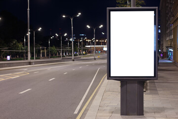 Vertical billboard advertising in the night city. Descent of the road. Mock-up.