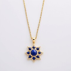A gold necklace with a blue gemstone pendant in the shape of a star.