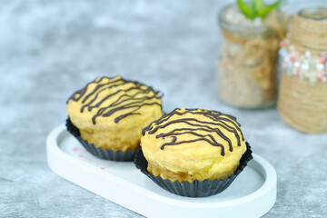 Cream Puffs Delicate ChocolateDrizzled Pastries on White Tray