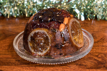 Traditional Festive Christmas Pudding, Fruit Cake on plate. 
