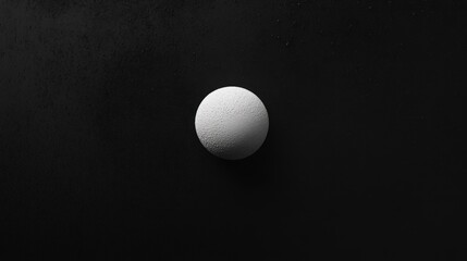 Abstract Monochrome Sphere on Dark Background: A Study in Contrast and Minimalism