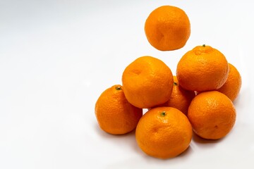 Fresh, ripe tangerines on a white background.