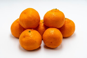 Fresh, ripe tangerines on a white background.