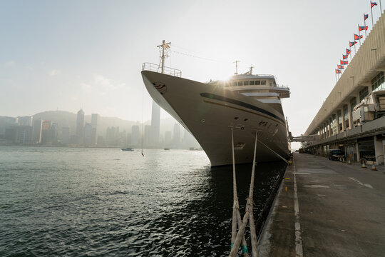 Hong Kong, China - February 02, 2019: a view of Hong Kong Island from Tsim Sha Tsui, with the Asuka II cruise ship in the foreground at Ocean Terminal, Harbour City.