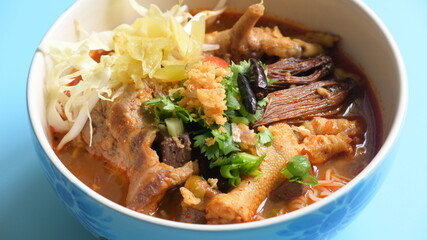 rice vermicelli with northern thai curry sauce on blue background
