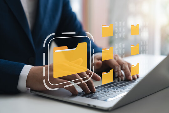 Document management system, DMS, company employees manage folders via laptop, access document information with document management software, search for business information, manage corporate files.