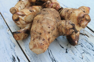 A typical Indonesian food is a type of tuber called midra on a wooden table


