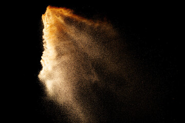 Sand flying explosion isolated on black background ,throwing freeze stop motion object design.