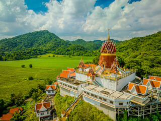 Majestic Wat Khao Phrom Sawan stands proud among lush green mountains in Saraburi, Thailand on...