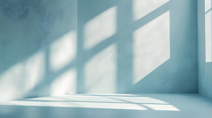 A minimal abstract light blue background is ideal for product presentations, with shadows and light casting from windows on a plaster wall.