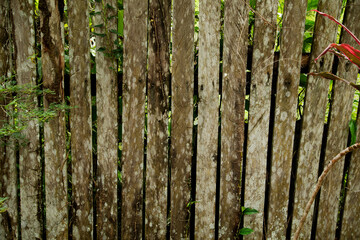 Wood aged and rusted from exposure to sun and rain. The wood shows signs of chipped aging.  wood showing its rough textures and aged patterns, rustic.vintage charm.
