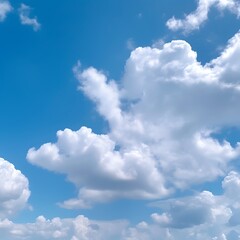 Obraz premium Beautiful fluffy white clouds drift across a vibrant blue sky