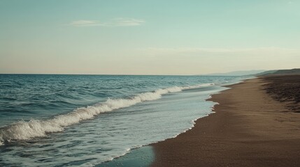 Obraz premium Serene Beach with Gentle Waves and Calm Waters