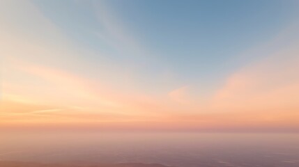 Serene Pastel Sunset Sky Over Hazy Landscape