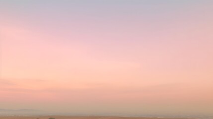 Obraz premium Pastel Sunset Sky Over Distant Landscape