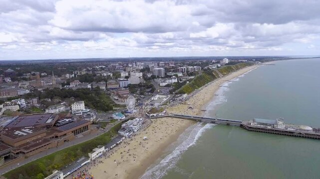 Stunning aerial footage of Bournemouth beach and pier, featuring golden sands, vibrant seaside activities, and scenic coastal views. Perfect for travel, tourism, and coastal visuals.